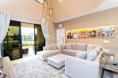 a living room with a white couch and chairs at Gorgeous 4Bd Close to Disney @ Magic Village 7581 in Orlando