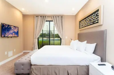 a bedroom with a large white bed and a window at Gorgeous 4Bd Close to Disney @ Magic Village 7581 in Orlando