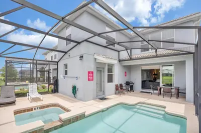 a house with a swimming pool and a patio at LAKEVIEW Home w Private Pool FREE Water Park in Kissimmee