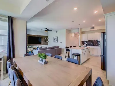 a dining room and kitchen with a table and chairs at Cute Lakeview 2BR Condo with 2 Clubhouses in Kissimmee