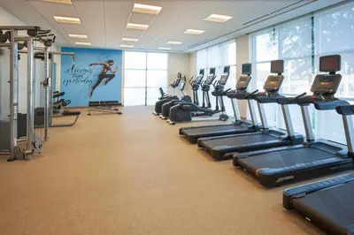 a gym with a row of treadmills and machines at SpringHill Suites by Marriott Winter Park in Orlando