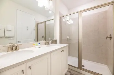 a white bathroom with a sink and a shower at Sky Blue Cottage With Private Pool Near Disney With Margaritaville Resort & Island H2O Access - 8045Kd in Orlando