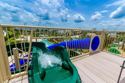 a water slide on a balcony at a resort at Cozy Condo Near Disney wPool View FREE WaterPark in Kissimmee