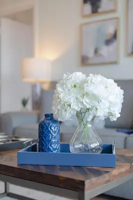 a vase with white flowers sitting on a table at Top floor condo with view of lake, pool and fireworks! Next to Convention Center! in Orlando