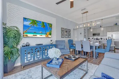 a living room with a table and a dining room at Top floor condo with view of lake, pool and fireworks! Next to Convention Center! in Orlando