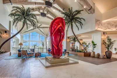 a large red sculpture in a lobby with palm trees at Margaritaville Cottage, PRIVATE POOL, Near Disney in Orlando