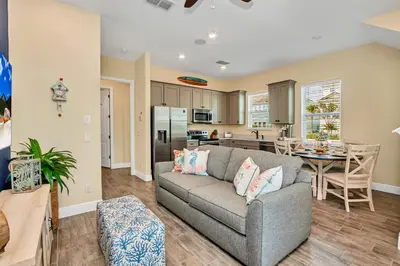 a living room with a couch and a kitchen at 8044 Sandy Toes Way in Orlando