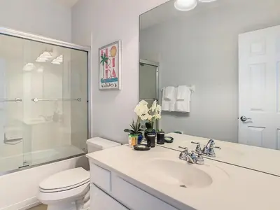 a white bathroom with a sink and a toilet at Stylish Vista Cay Townhome Near Conv. Ctr I-Dr. in Orlando