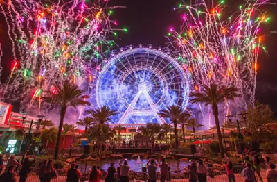 a ferris wheel and fireworks at a carnival at night at Bposhtels Orlando Florida Mall in Orlando