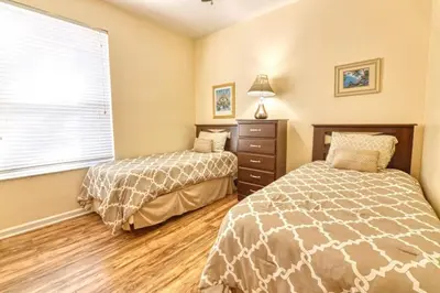a bedroom with two beds and a window at Windsor Palms Resort 3 Bedroom Condo 6 Miles to Disney in Kissimmee