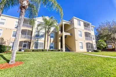 a large house with palm trees in front of it at Windsor Palms Resort 3 Bedroom Condo 6 Miles to Disney in Kissimmee