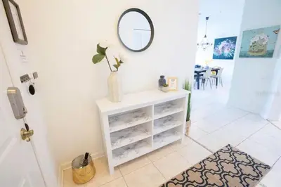 a room with a white dresser with a mirror at Windsor Palms Resort 3 Bedroom Condo 6 Miles to Disney in Kissimmee