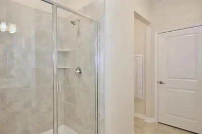 a bathroom with a shower with a glass door at Great apartment in Storey Lake resort with great amenities next to Disney! in Kissimmee