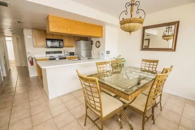 a kitchen and dining room with a table and chairs at Royal Palm Bay 3 Bedroom Condo Resort Pool 10 Min Disney in Kissimmee