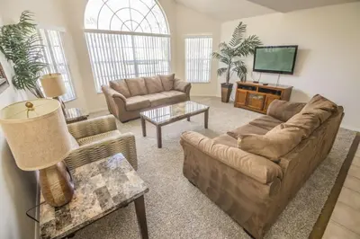 a living room with a couch and a tv at Royal Palm Bay 3 Bedroom Condo Resort Pool 10 Min Disney in Kissimmee
