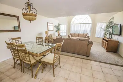 a living room with a table and a couch at Royal Palm Bay 3 Bedroom Condo Resort Pool 10 Min Disney in Kissimmee
