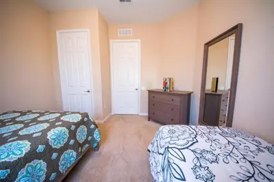 a bedroom with a bed and a dresser and a mirror at Vista Cay Resort 3 Bedroom Condo 2 Miles to Universal Orlando in Orlando