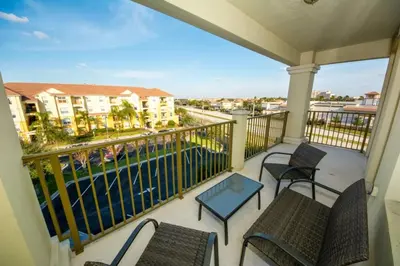 a balcony with chairs and a view of a pool at Vista Cay Resort 3 Bedroom Condo 2 Miles to Universal Orlando in Orlando