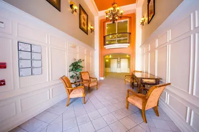 a hallway with a table and chairs in a building at Vista Cay Resort 3 Bedroom Condo 2 Miles to Universal Orlando in Orlando
