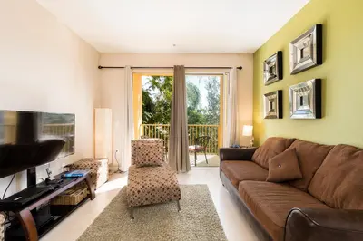 a living room with a couch and a television at Spacious 2BR 2BA with Balcony 5 Mins to Convention Center & Epic Universe in Orlando