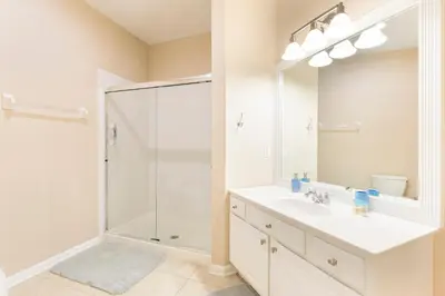a bathroom with a shower and a sink and a mirror at Spacious 2BR 2BA with Balcony 5 Mins to Convention Center & Epic Universe in Orlando