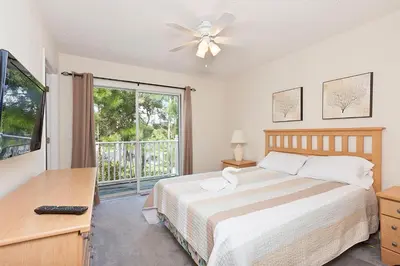 a bedroom with a bed and a large window at 3Br 3Bath Private Townhome 10min Disney 1270ft in Kissimmee