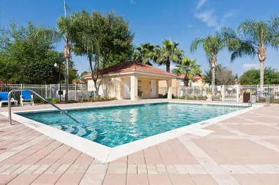 a swimming pool with a gazebo in a yard at 3Br 3Bath Private Townhome 10min Disney 1270ft in Kissimmee