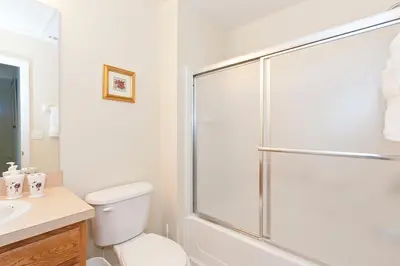 a bathroom with a shower and a toilet and a sink at 3Br 3Bath Private Townhome 10min Disney 1270ft in Kissimmee