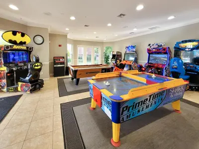 a living room with a pool table and arcade games at 3Br 2Bath Condo Balcony 5min Conv Center 1388ft in Orlando