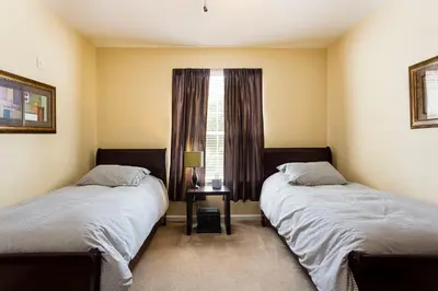 two beds in a room with a window at 3Br 2Bath Condo Balcony 5min Conv Center 2087ft in Orlando