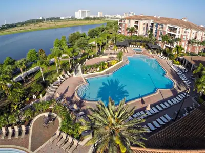 an aerial view of a swimming pool next to a body of water at 3Br 2Bath Condo Balcony 5min Conv Center 2087ft in Orlando