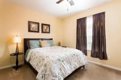 a bedroom with a bed and a window at 3Br 2Bath Condo Balcony 5min Conv Center 2087ft in Orlando