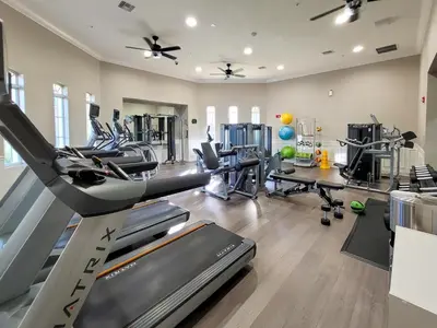a fitness room with treadmills and cardio machines at Spacious Vista Cay Condo near Universal Studios in Orlando