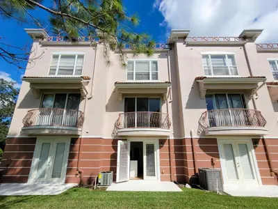 an image of a pink building with balconies at 3Br 4 Bath Large Condo 5min Conv Center 1732ft in Orlando