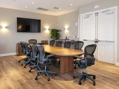a conference room with a wooden table and chairs at 3Br 4 Bath Large Condo 5min Conv Center 1732ft in Orlando