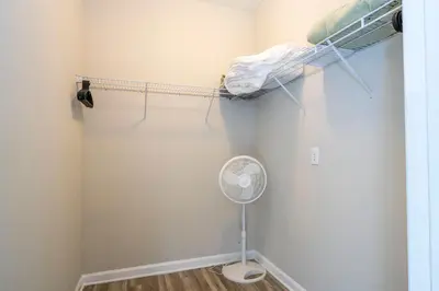 a room with a closet with a fan and a bed at Renovated 4Br Condo 5min Conv Center in Orlando