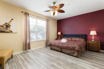 a bedroom with a bed and a ceiling fan at Renovated 4Br Condo 5min Conv Center in Orlando