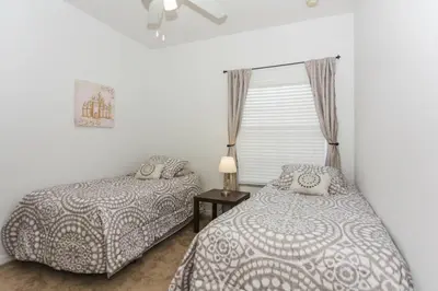 a bedroom with two beds and a window at 5Br 3Bath Private Townhome 13min Disney 1496ft in Kissimmee