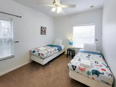 a bedroom with two beds and a ceiling fan at 5Br 3Bath Private Townhome 13min Disney 1496ft in Kissimmee