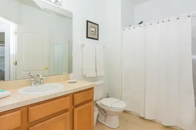 a bathroom with a sink and a toilet and a shower at 5Br 3Bath Private Townhome 13min Disney 1496ft in Kissimmee