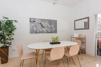 a dining room with a white table and chairs at 5Br 3Bath Private Townhome 13min Disney 1496ft in Kissimmee