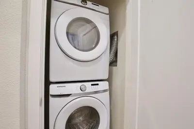 a washing machine and a washer in a room at Great 4 bedroom townhouse in lux resort Hidden Forest, with private pool! in Orlando