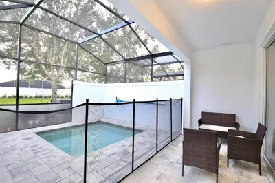 an indoor swimming pool with a glass house at Great 4 bedroom townhouse in lux resort Hidden Forest, with private pool! in Orlando
