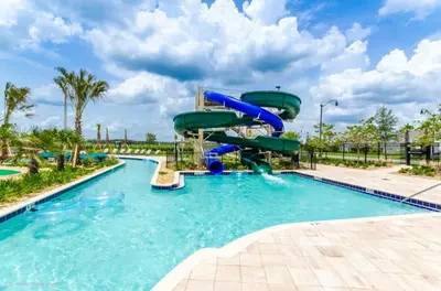 a water slide in a pool at a resort at 4 Bed Storey Lake Resort With Lazy River townhouse in Kissimmee
