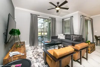 a living room with a couch and a table at 4 Bed Storey Lake Resort With Lazy River townhouse in Kissimmee