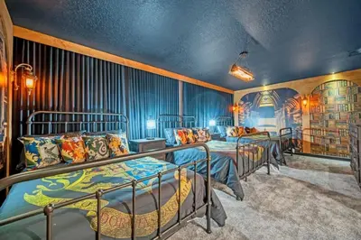 a group of beds in a room with blue walls at 9 Bed Storey Lake Villa Pictures Coming Soon home in Kissimmee