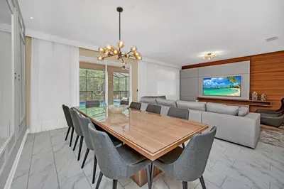 a dining room with a table and chairs at 9 Bed Storey Lake Villa Pictures Coming Soon home in Kissimmee