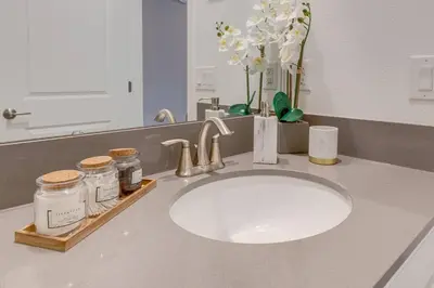 a bathroom counter with a sink and a mirror at NEWLY LISTED Townhouse Storey Lake, Free Waterpark in Kissimmee
