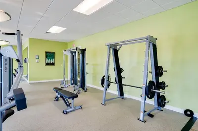 a gym with several tread machines in a room at NEWLY LISTED Townhouse Storey Lake, Free Waterpark in Kissimmee