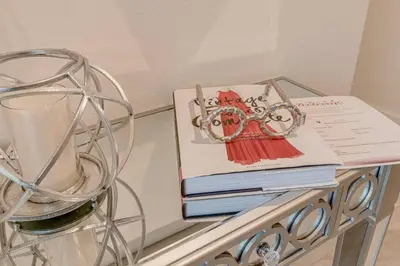 a stack of books on a glass table with a book at NEWLY LISTED Townhouse Storey Lake, Free Waterpark in Kissimmee